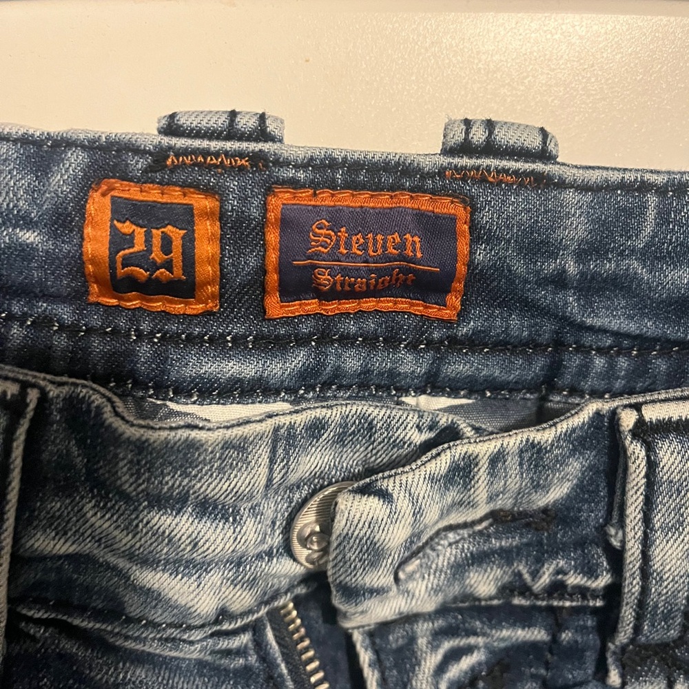 Rock Revival Men's Blue Straight Jeans have been hemmed to a 29” length